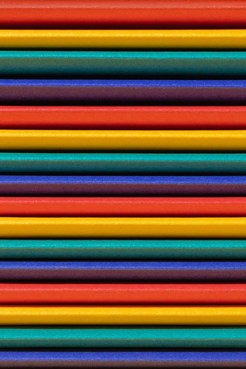 Stack of colorful straws in various bright colors.