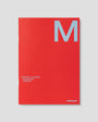 Red planner with a large 'M' on a gray background
