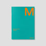Teal planner with an orange 'M' on a gray background