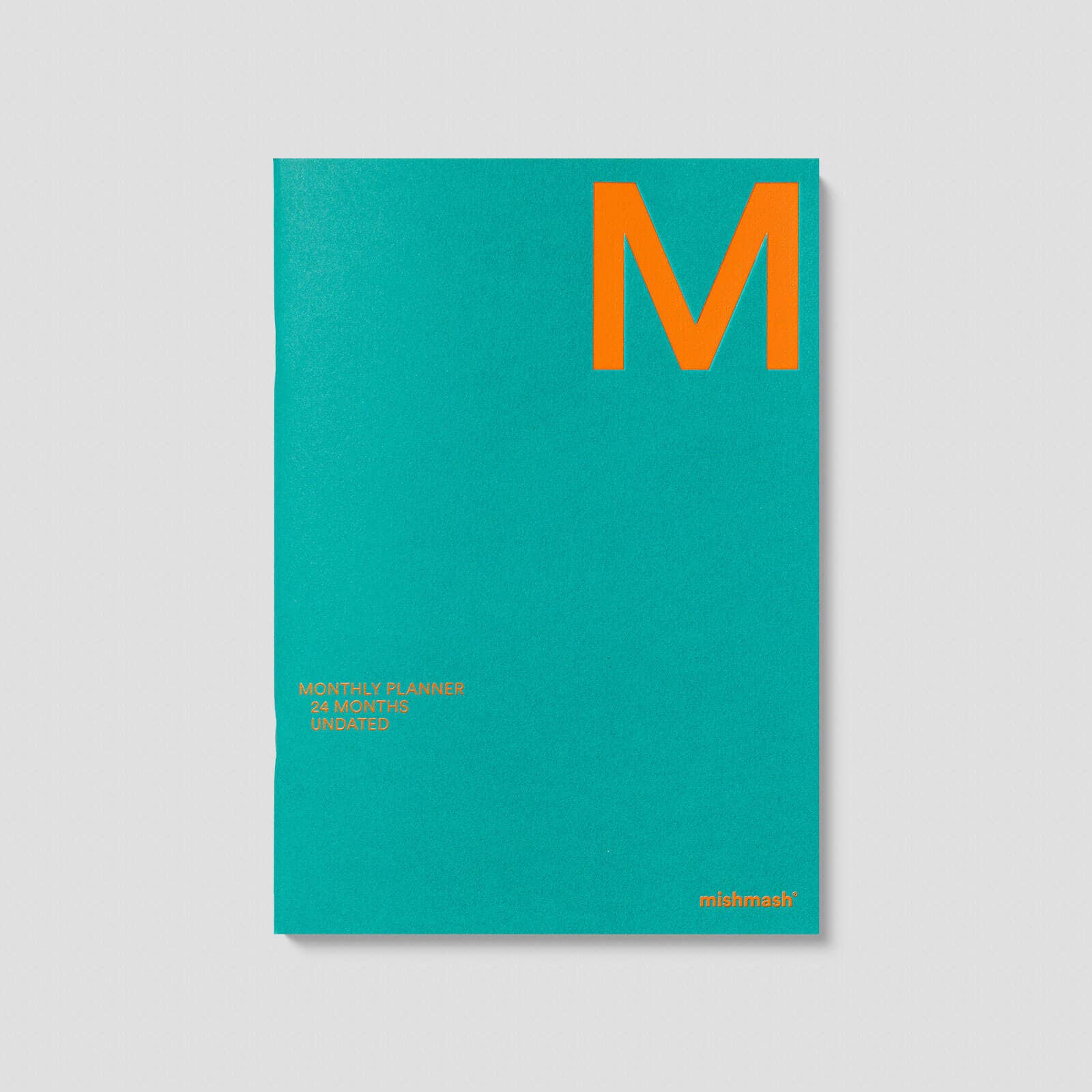 Teal planner with an orange 'M' on a gray background