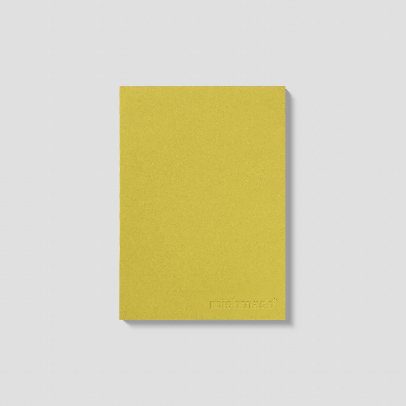 Yellow notebook with 'mous' branding on a light gray background
