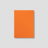 Orange notebook with 'mismast' branding on a light gray background