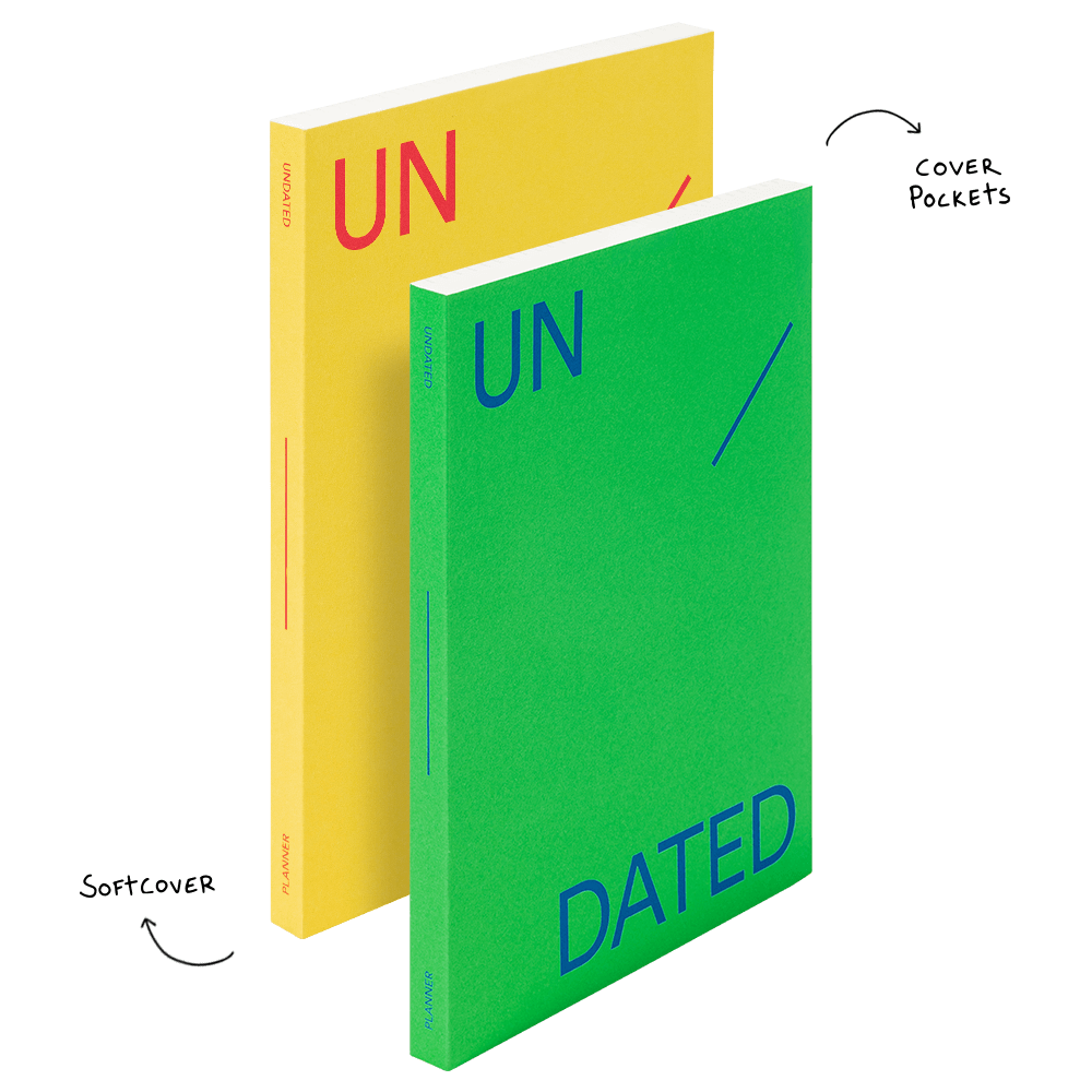 Two books, one yellow and one green, with 'UN' and 'DATED' text on a black background.