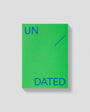 Green book with 'UN DATED' text on a gray background