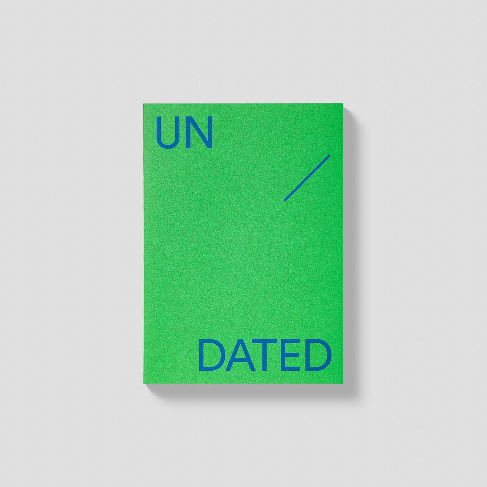 Green book with 'UN DATED' text on a gray background