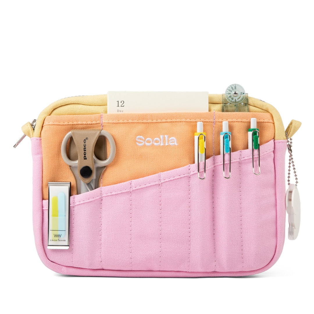 Pink pencil case with compartments for stationery items on a white background